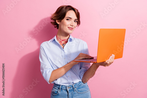 Photo of gorgeous successful girl hold use wireless laptop coworking write email isolated on pink color background