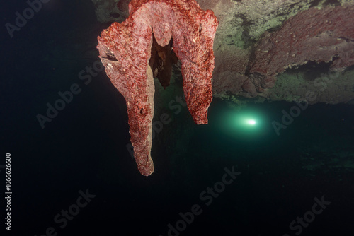 Diving in Mexican Cenote underwater cave with green gas cloud