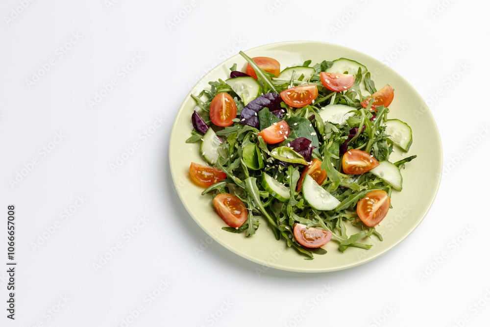Vegetable salad of tomato, cucumber, greens with sesame on the plate. Vegetable salad of tomato, cucumber, greens with sesame on the plate.