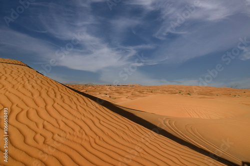 Lonely sand dunes under dramatic evening sunset sky at drought desert landscape