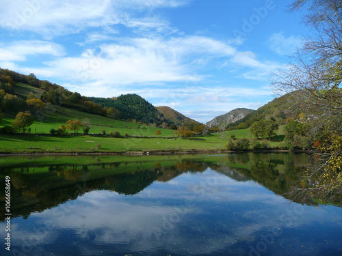 lake whit reflections of the mountains on a sunny autumn morning in france photo