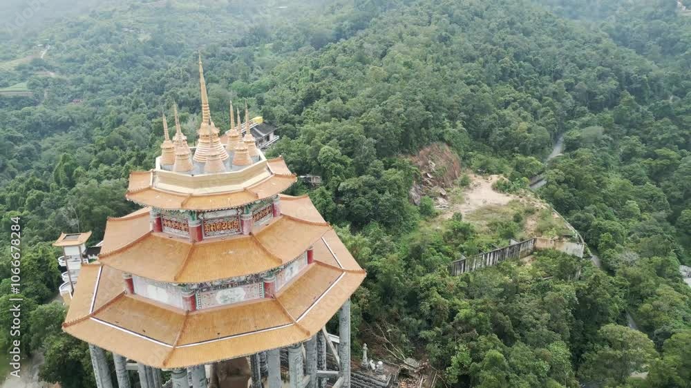 aerial of kek lok si temple Penang island Malaysia buddha scullpture close up drone fly above green vegetation jungle aerial of kek lok si temple Penang island Malaysia buddha scullpture close up drone fly above green vegetation jungle