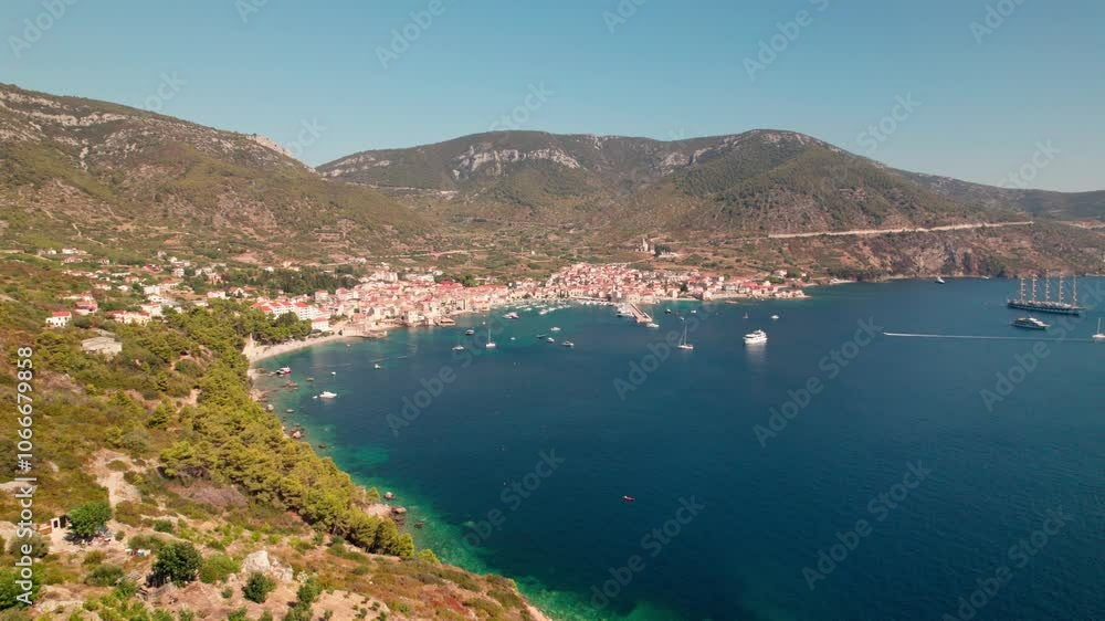 Mediterranean Town Of Komiza On Sunny Day. Vis Island, Croatia. aerial panning shot Mediterranean Town Of Komiza On Sunny Day. Vis Island, Croatia. aerial panning shot