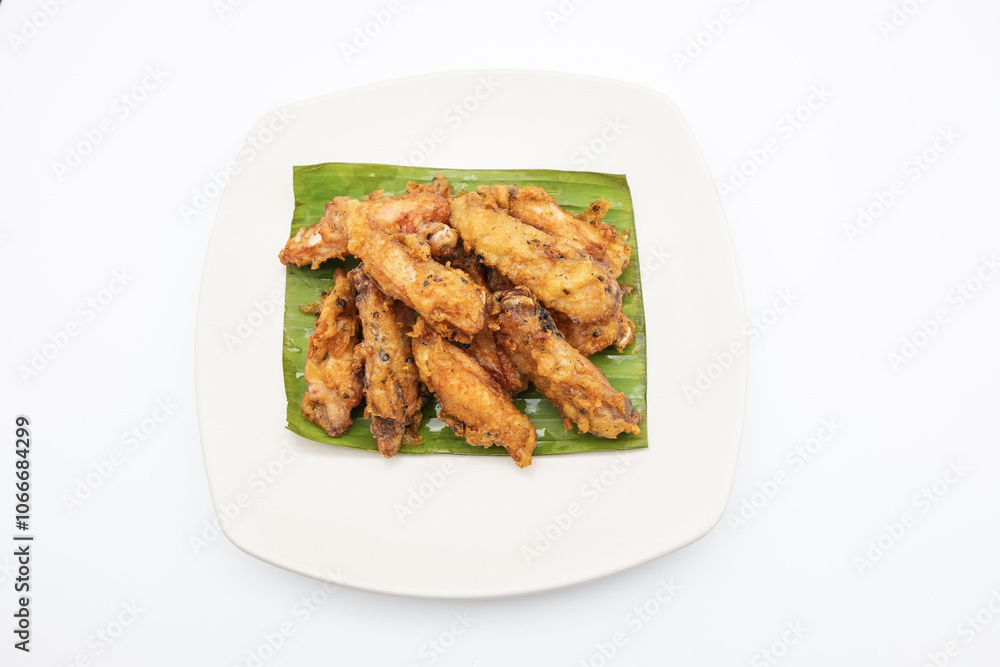 Fried chicken on white plate with white background, asia food, unhealthy food Fried chicken on white plate with white background, asia food, unhealthy food