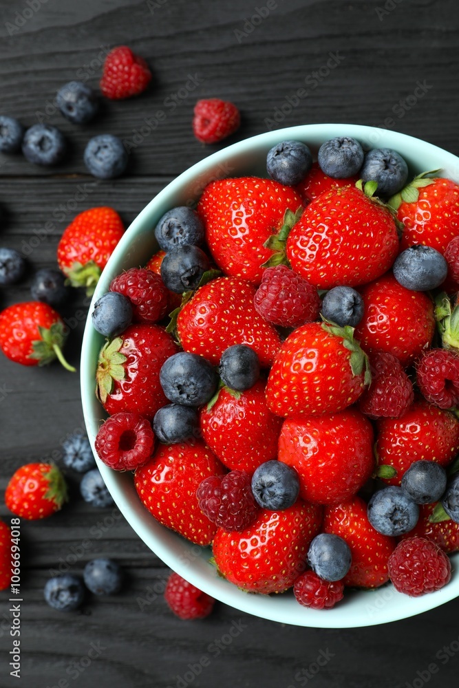 Different fresh ripe berries in bowl Different fresh ripe berries in bowl