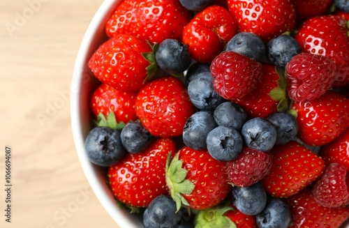 Different fresh ripe berries in bowl 