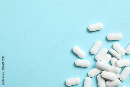 White medicine pills on color background