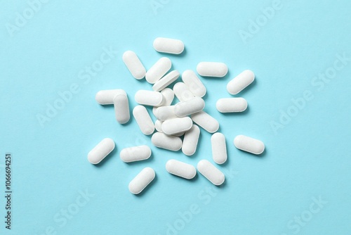 White medicine pills on color background