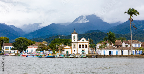Panoramic view of Paraty Bay, historic center of Paraty and tourist boats at the pier in Rio de Janeiro, Brazil. World Heritage Site on the Brazilian Coast