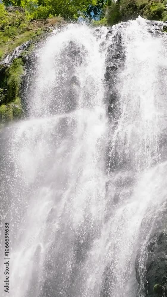 Aerial drone of waterfall in a mountain canyon surrounded by jungle. Slow motion. Balea Falls in the jungle. Negros, Philippines. Aerial drone of waterfall in a mountain canyon surrounded by jungle. Slow motion. Balea Falls in the jungle. Negros, Philippines.
