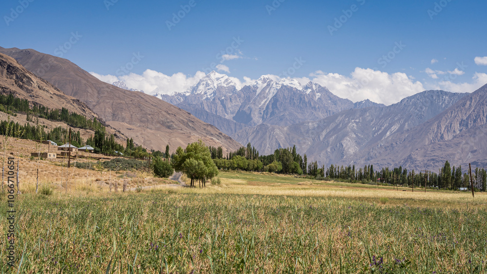 Rural landscape view of snow-capped Hindu Kush mountain range near Ishkashim, Wakhan Corridor, Gorno-Badakhshan, Tajikistan Pamir