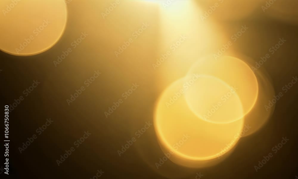 A glowing golden lens flare with soft bokeh overlays, seamlessly a dark background. A glowing golden lens flare with soft bokeh overlays, seamlessly a dark background.