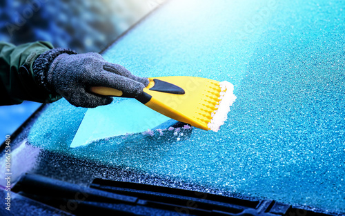 Clearing and remove snow from windshield, Scraping ice. Winter season car window cleaning. Copy space for your text. Panoramatic banner.