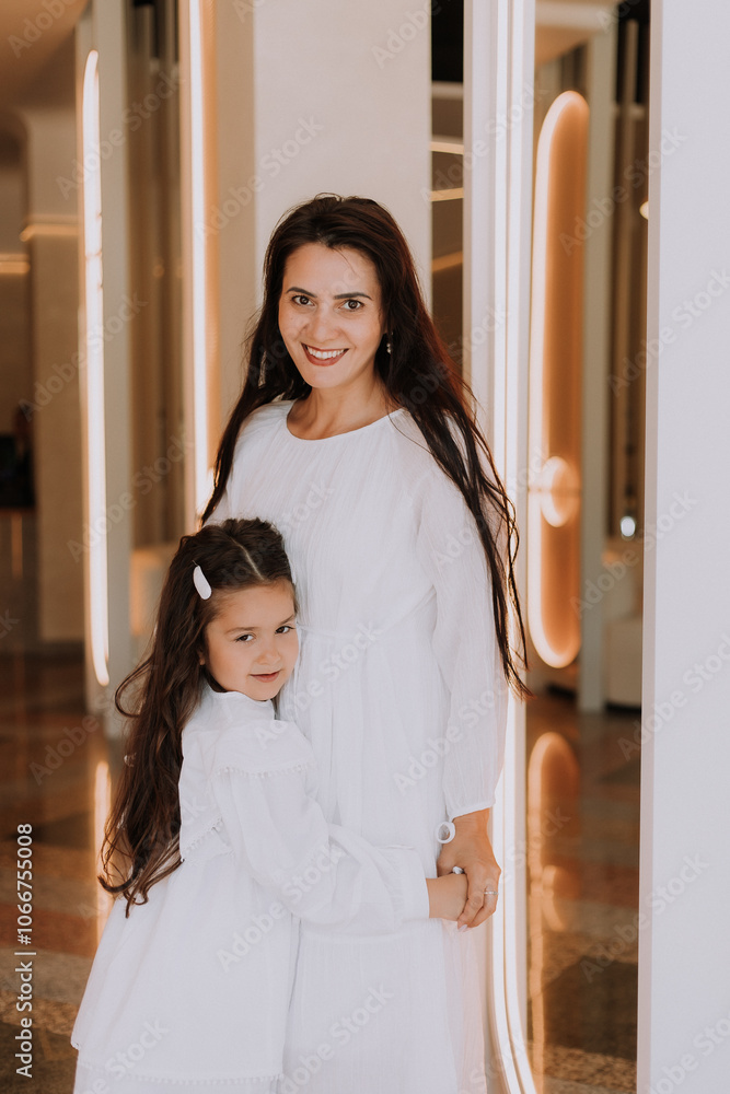 mom and daughter have breakfast in a cafe