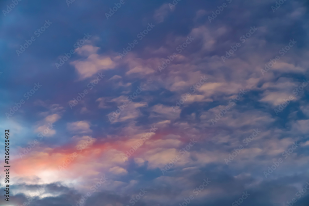Soft pink and purple clouds in a colorful sunset sky. Abstract nature background. Design for wallpaper, poster, banner, greeting card, invitation. Soft pink and purple clouds in a colorful sunset sky. Abstract nature background. Design for wallpaper, poster, banner, greeting card, invitation.