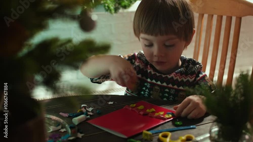 Small child makes special DIY Christmas holiday cards