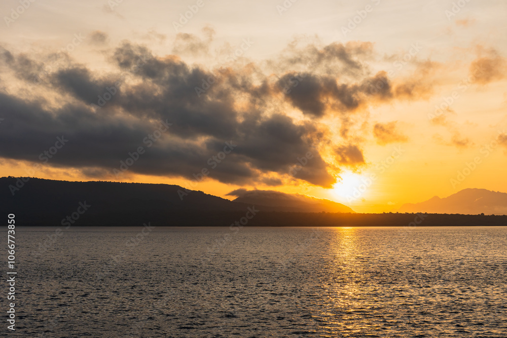 Fototapeta premium Beautiful Blazing Sunrise and golden sky landscape over the Sea.