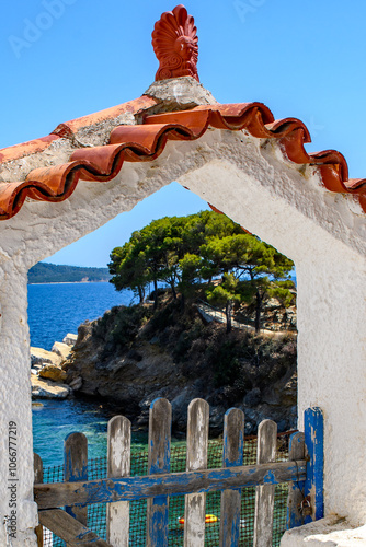 Through the gate, sea view looking down on the beach at Plakes. Part of the Sporades islands, Greece. Holiday and vacation picture. photo