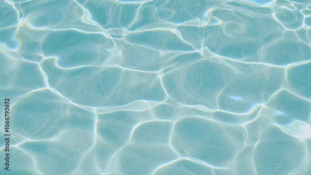 Close-up of sun-dappled blue water, where light creates dynamic wave patterns and reflections on the surface. Water backdrop. Summer concept