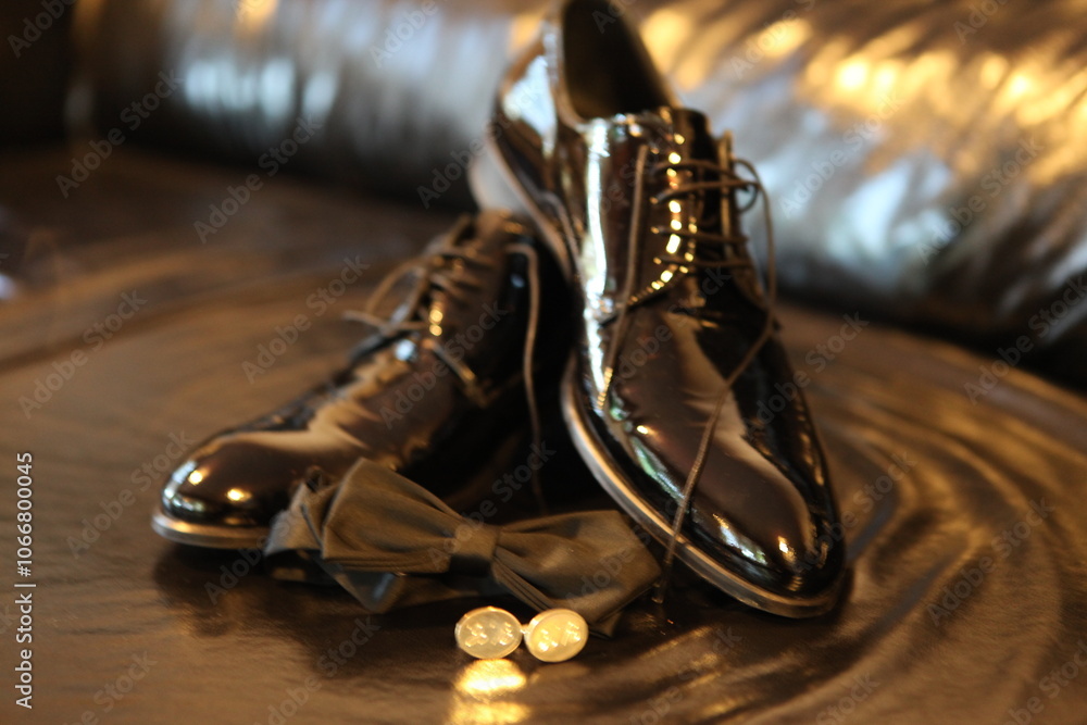 Close-up of Groom's Accessories: Black Leather Shoes, Bow Tie and Cufflinks