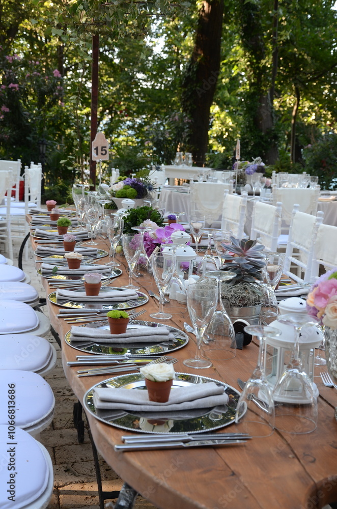 Outdoor Wedding Reception: Jars with Flowers and Candles on Wooden Table