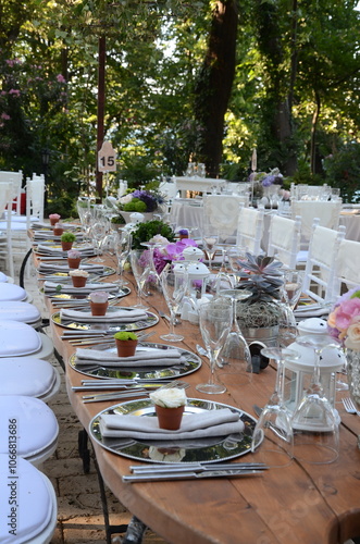 Obraz na płótnie Outdoor Wedding Reception: Jars with Flowers and Candles on Wooden Table w salonie