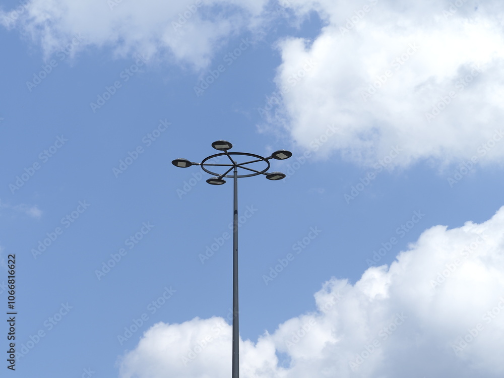 Street Lamp Against Blue Sky with Scattered Clouds in Daylight Background Street Lamp Against Blue Sky with Scattered Clouds in Daylight Background