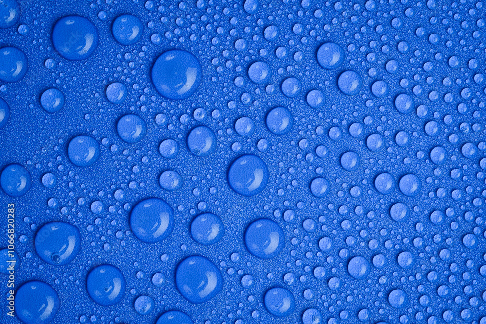 Close up of water droplets on blue background. Macro photo. Top view. Close up of water droplets on blue background. Macro photo. Top view.