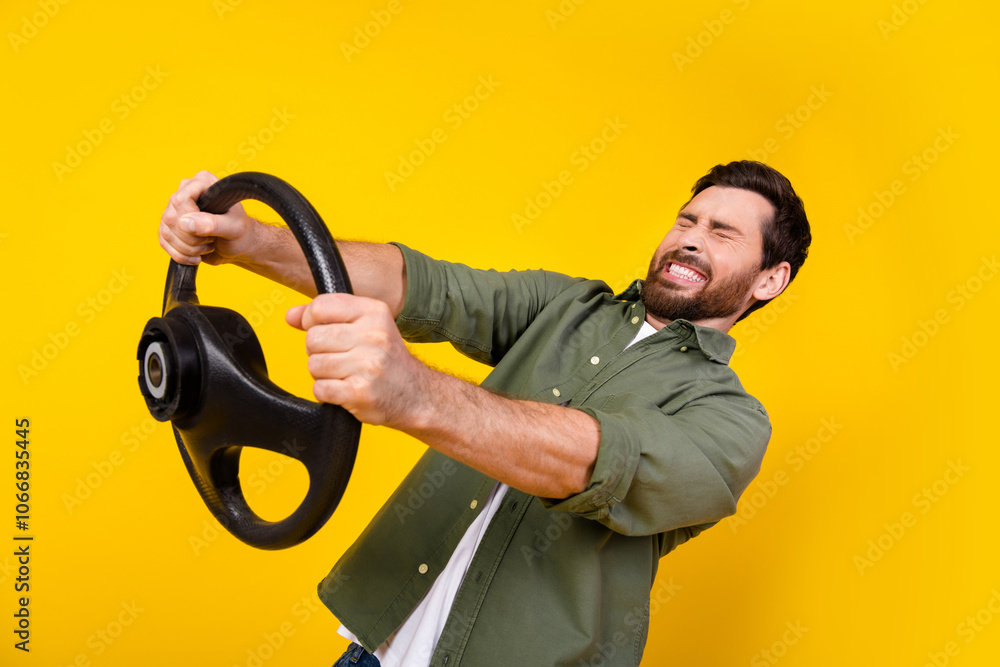 Photo of nice young man closed eyes hold wheel wear shirt isolated on yellow color background