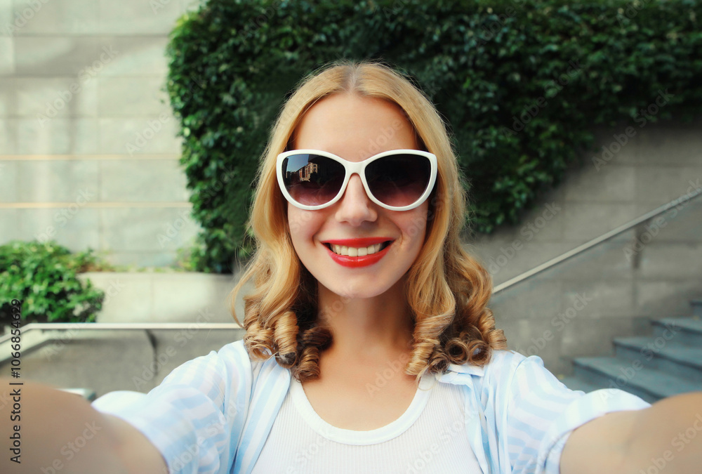 Happy cheerful smiling young woman taking selfie with phone, joyful girl using smartphone in city Happy cheerful smiling young woman taking selfie with phone, joyful girl using smartphone in city