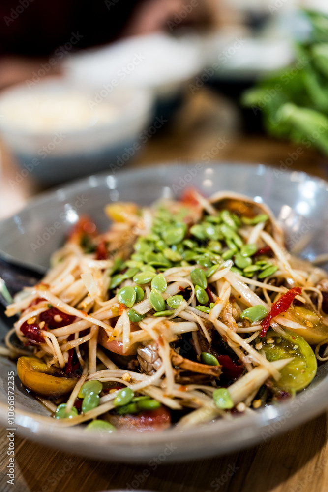 Papaya salad with crab and fermented fish decoration seed Acacia, a popular food among Thai people Papaya salad with crab and fermented fish decoration seed Acacia, a popular food among Thai people