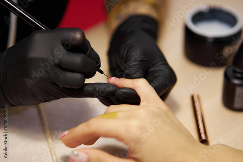 Women's manicure. Female hand undergoing a manicure procedure. The master does a women's manicure. A manicurist files a women's nails in a salon. Hygiene and hand care for woman. manicure design.