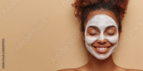
Beautiful woman on the right side of the frame with smiling eyes closed while receiving a face mask at a beautiful med spa at cream background