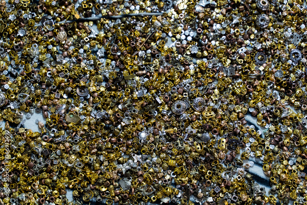 Closeup of multicolored beads scattered on a textured surface