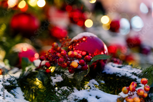 Obraz na płótnie Festively decorated Christmas setting featuring bright red ornaments and a snowy background w salonie