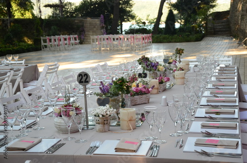 Obraz na płótnie Beautiful Wedding Decor: Tables with Lush Floral Arrangements and Candles Outdoors at Evening w salonie