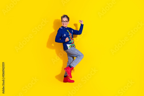 Photo of holly jolly lovely senior woman wear blue stylish clothes empty space isolated on yellow vivid color background