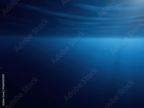 Dark blue ocean surface seen from underwater with sun rays filtering through, creating a mesmerizing and mysterious ambiance, surface, dark blue