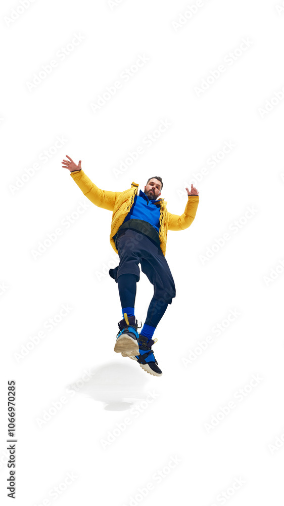 Man in a yellow jacket and blue sneakers, captured mid-air with open stance against white studio background, exuding confidence and energy. Concept of fashion and style, beauty, trendy. Ad Man in a yellow jacket and blue sneakers, captured mid-air with open stance against white studio background, exuding confidence and energy. Concept of fashion and style, beauty, trendy. Ad