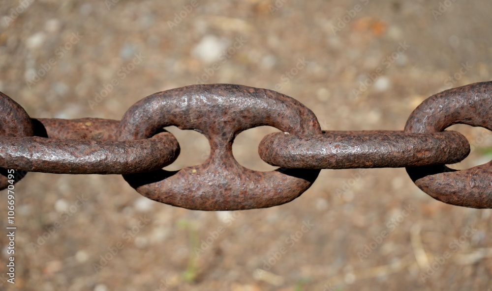Close up of strong heavy brown rusty chain links with speckled brown bokeh background. Close up of strong heavy brown rusty chain links with speckled brown bokeh background.