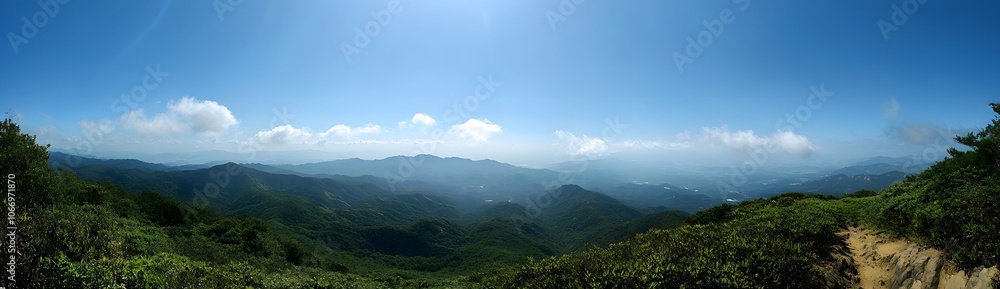 Panoramic View of Lush Green Mountains Under a Blue Sky Panoramic View of Lush Green Mountains Under a Blue Sky