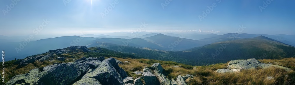 Fototapeta premium Mountainous Landscape with Rocks and Grass Under a Clear Blue Sky