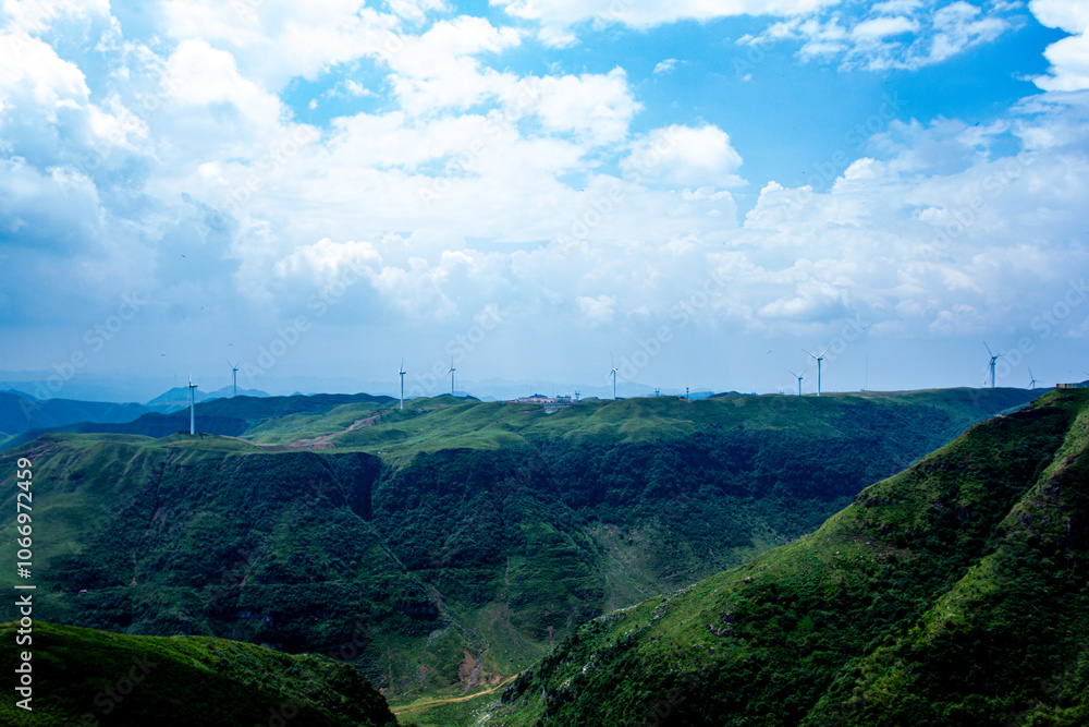 a green mountain with a white water stream running down it a green mountain with a white water stream running down it