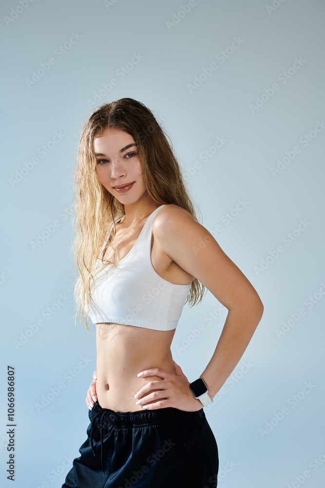 A beautiful athlete radiates confidence and emotion while posing against a neutral backdrop. A beautiful athlete radiates confidence and emotion while posing against a neutral backdrop.