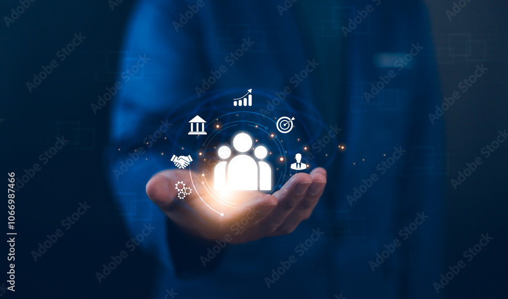 Employing CRM, the businessman manages global customer networks, leveraging technology for data exchanges and development, context of customer service, banking, and strategic business initiatives.