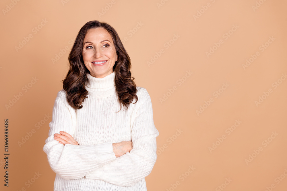 Photo of charming lovely senior woman crossed arms wear white trendy clothes empty space isolated on beige color background Photo of charming lovely senior woman crossed arms wear white trendy clothes empty space isolated on beige color background