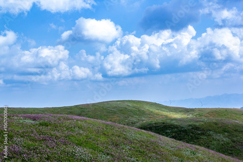 a mountain range with a blue sky and clouds