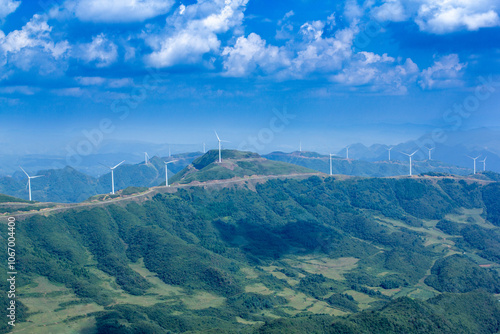 a mountain with a bunch of hills and a power line in the background