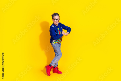 Photo of adorable cheerful pensioner wear blue stylish clothes have fun isolated on yellow color background