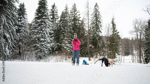 Ice Skating adventure with dogs and child in snowy forest